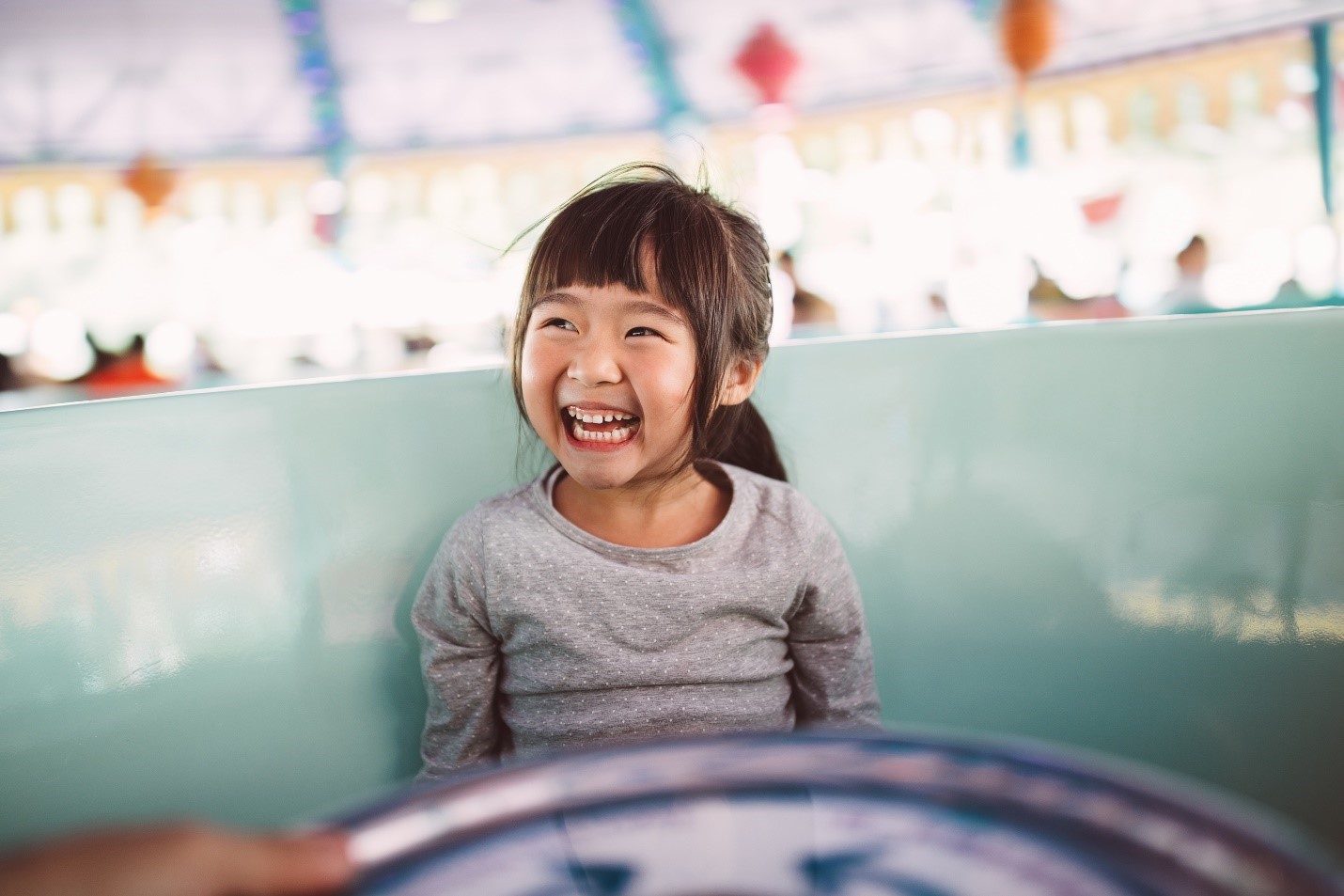 Laws and Regulations photo tile with a young girl laughing. 